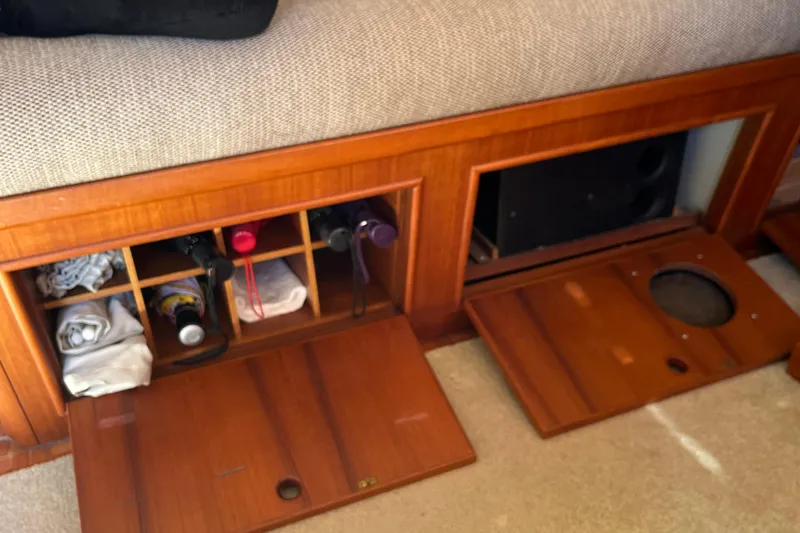Slide: The Image of Wooden storage compartments with wine bottles and towels on a 1991 Grand Banks 46 Motoryacht. - 64