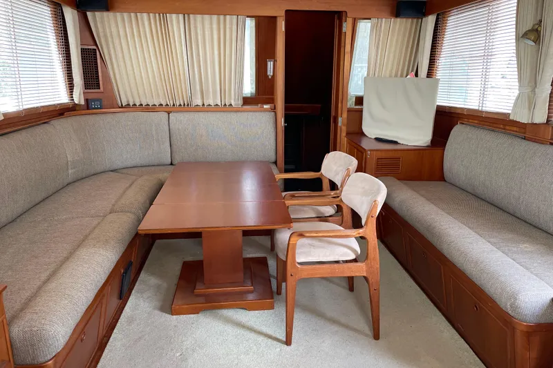 Slide: The Image of 1991 Grand Banks 46 Motoryacht deck with covered equipment and wooden accents. - 7