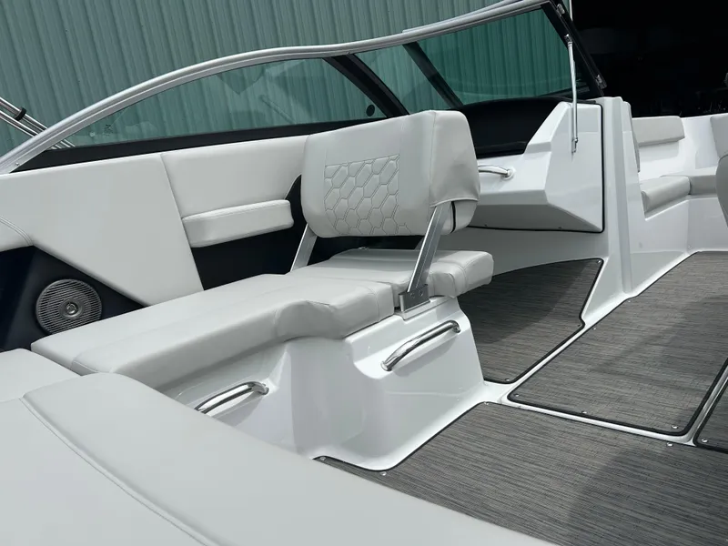 Slide: The Image of 2025 Four Winns H2 Freedom boat interior with sleek white seating and modern design. - 10