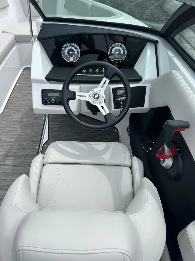 Slide: The Image of 2025 Four Winns H2 Freedom boat cockpit with modern steering and dashboard design. - 13