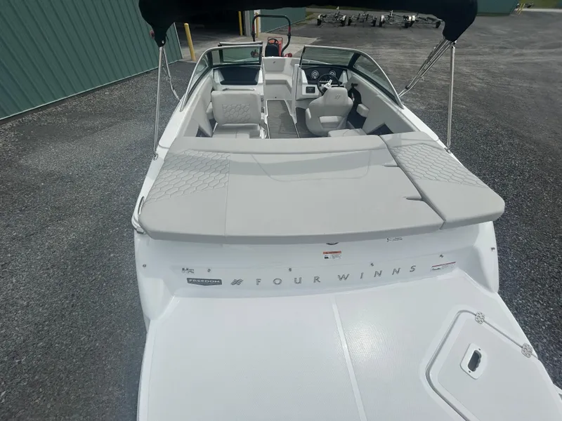 Slide: The Image of 2025 Four Winns H2 Freedom boat with spacious seating and sleek design. - 7