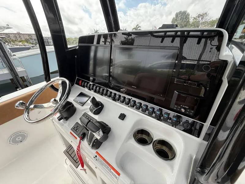 Slide: The Image of 2023 Sea Hunt Gamefish 30 helm with advanced controls and dual displays. - 10
