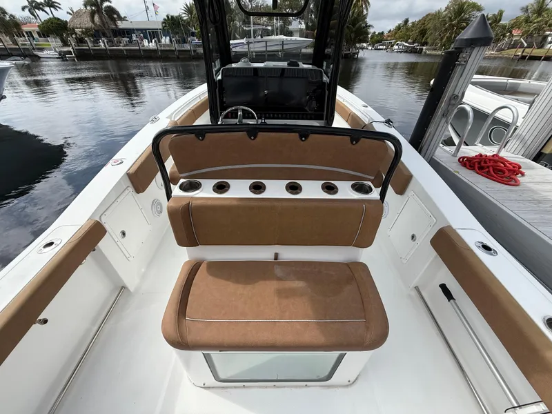 Slide: The Image of 2023 Sea Hunt Gamefish 30 Forward Seating boat interior with tan cushions and rod holders. - 14
