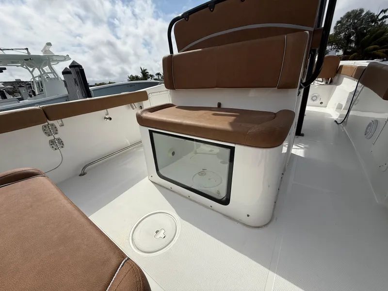 Slide: The Image of 2023 Sea Hunt Gamefish 30 Forward Seating with brown cushions and storage compartment. - 16