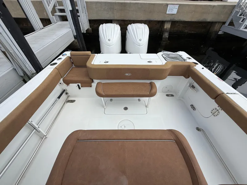 Slide: The Image of 2023 Sea Hunt Gamefish 30 boat with forward seating and twin engines at dock. - 19