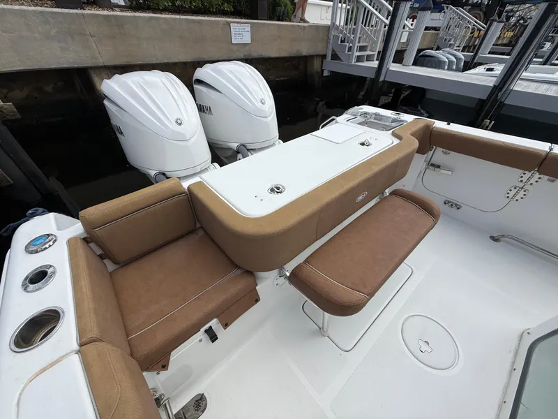 Slide: The Image of 2023 Sea Hunt Gamefish 30 boat with forward seating and twin outboard engines. - 22