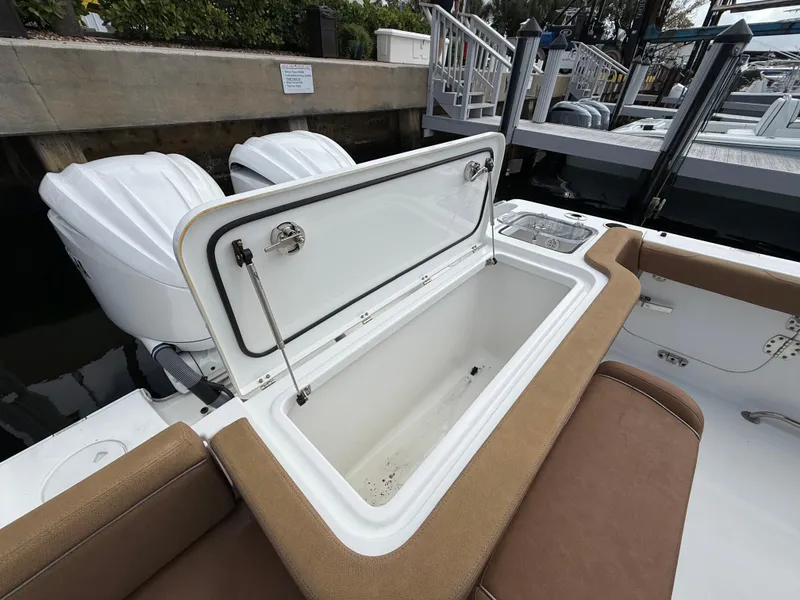 Slide: The Image of 2023 Sea Hunt Gamefish 30 boat with open storage compartment and twin engines. - 23