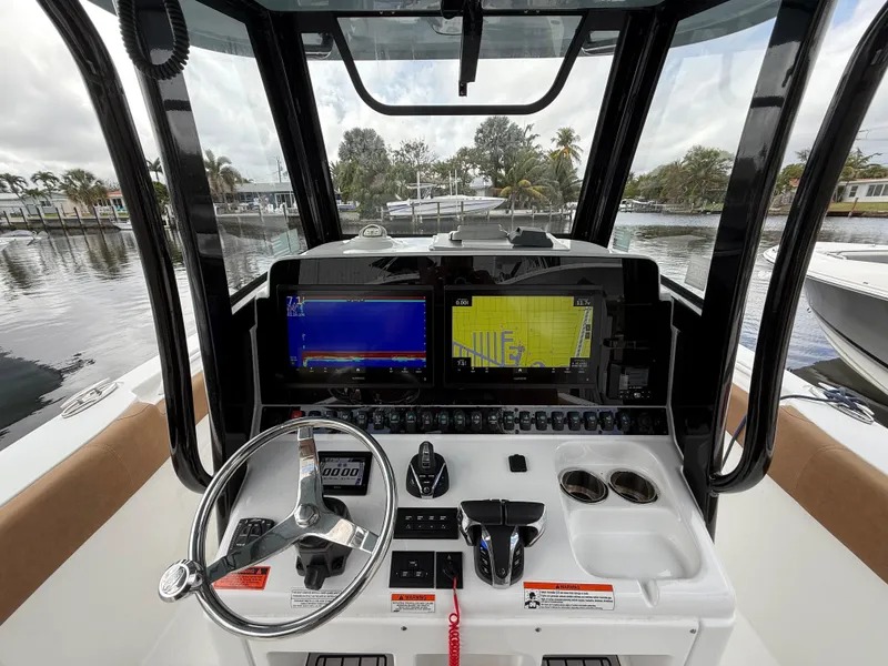 Slide: The Image of 2023 Sea Hunt Gamefish 30 helm with advanced navigation displays and controls. - 25