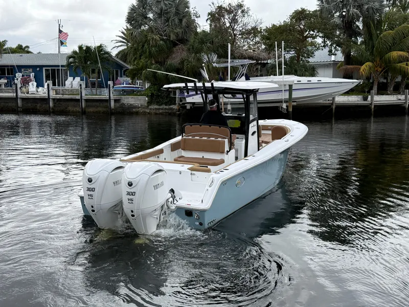 Slide: The Image of 2023 Sea Hunt Gamefish 30 boat with dual engines on a calm waterway. - 26