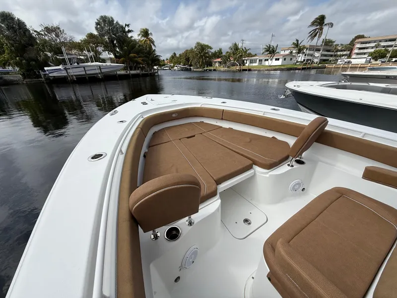 Slide: The Image of 2023 Sea Hunt Gamefish 30 with forward seating, docked in a scenic marina. - 3