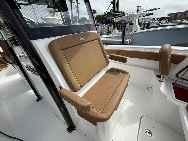 Slide: The Image of 2023 Sea Hunt Gamefish 30 Forward Seating with tan cushions and sleek design. - 5