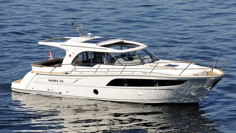 Slide: The Image of 2025 Marex 375 yacht cruising on calm blue waters. - 13