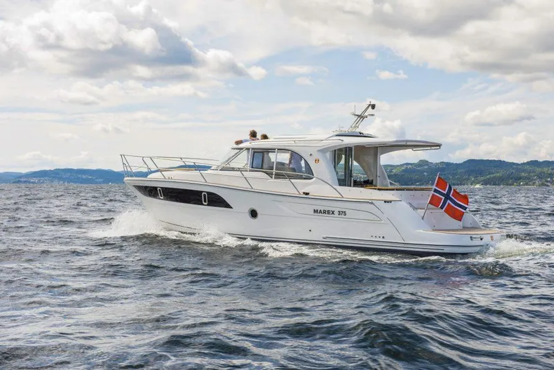 Slide: The Image of 2025 Marex 375 yacht cruising on open water with Norwegian flag. - 14