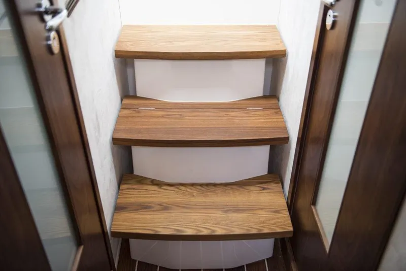 Slide: The Image of Wooden steps inside a 2025 Marex 375 boat, featuring elegant design and craftsmanship. - 22