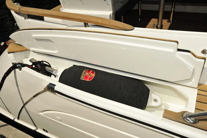Slide: The Image of 2025 Marex 375 boat storage compartment with fender and rope. - 24