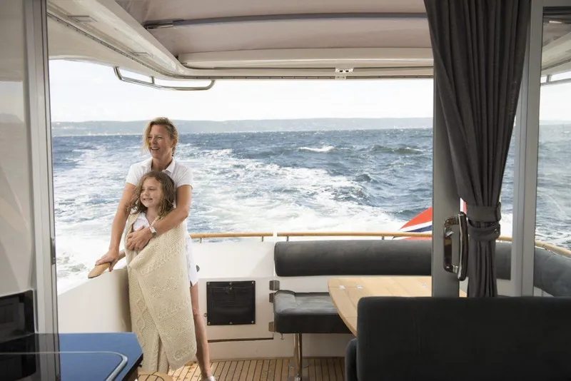 Slide: The Image of Family enjoying a cruise on a 2025 Marex 375 yacht, ocean view in background. - 34