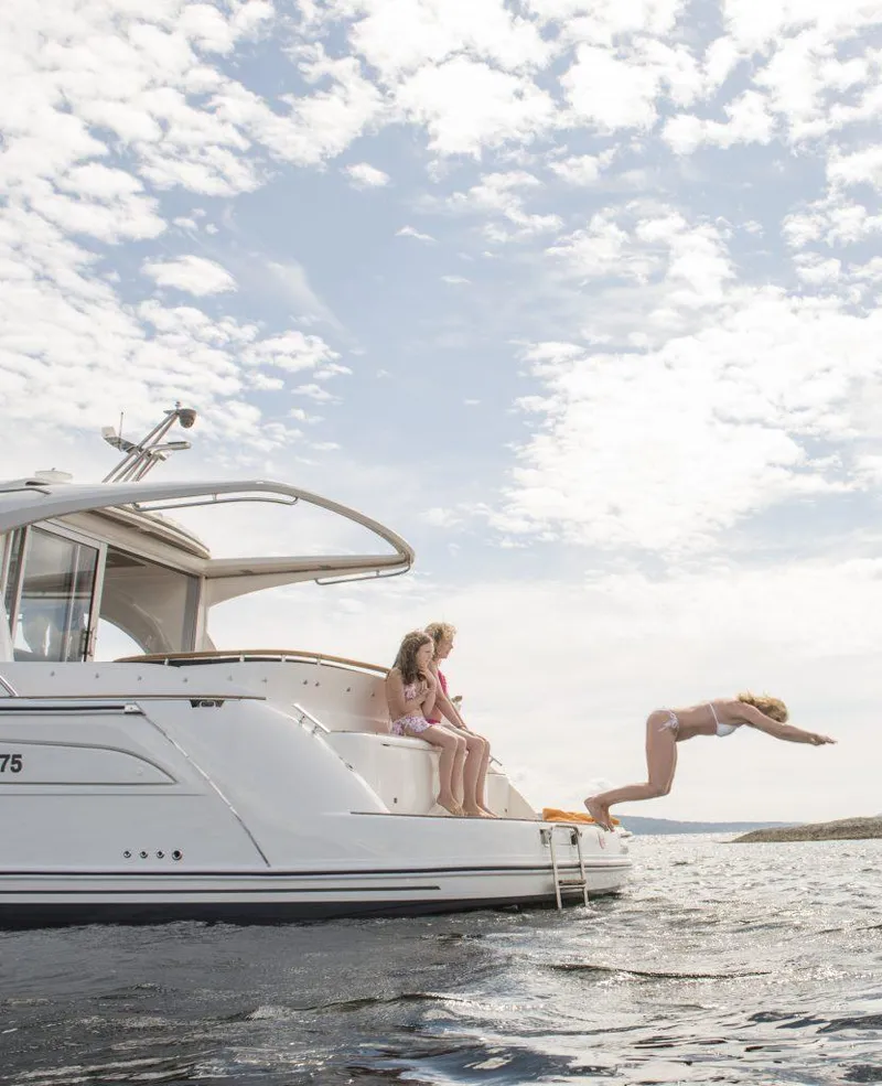 Slide: The Image of People enjoying a dive from a 2025 Marex 375 yacht under a partly cloudy sky. - 38