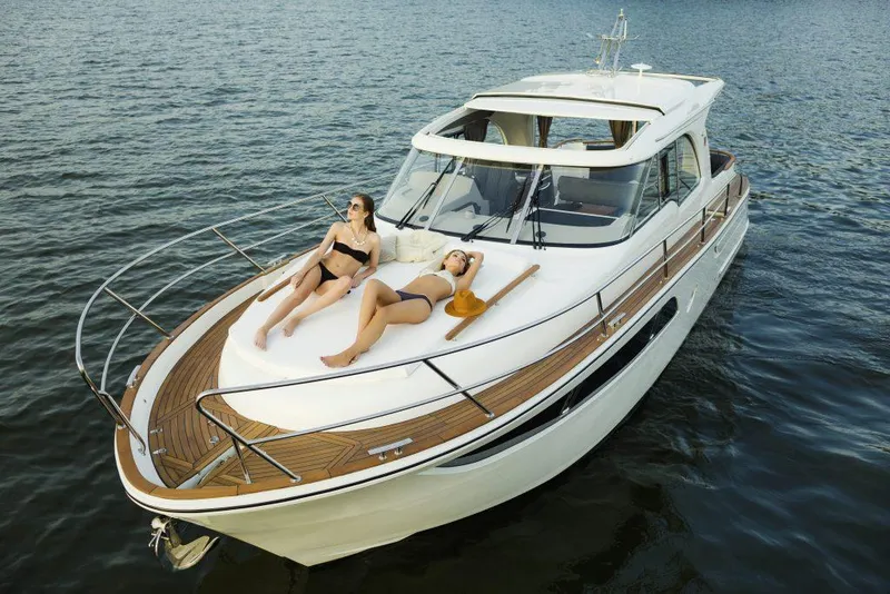Slide: The Image of 2025 Marex 375 yacht with two people sunbathing on deck, cruising on calm water. - 39