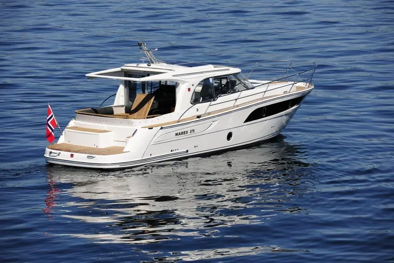 Slide: The Image of 2025 Marex 375 yacht cruising on calm blue waters. - 15