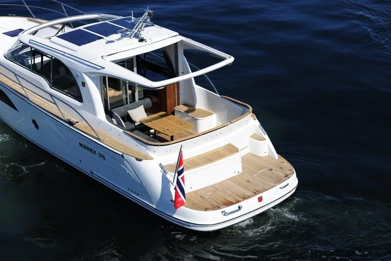 Slide: The Image of 2025 Marex 375 yacht cruising on open water, featuring sleek design and spacious deck. - 16