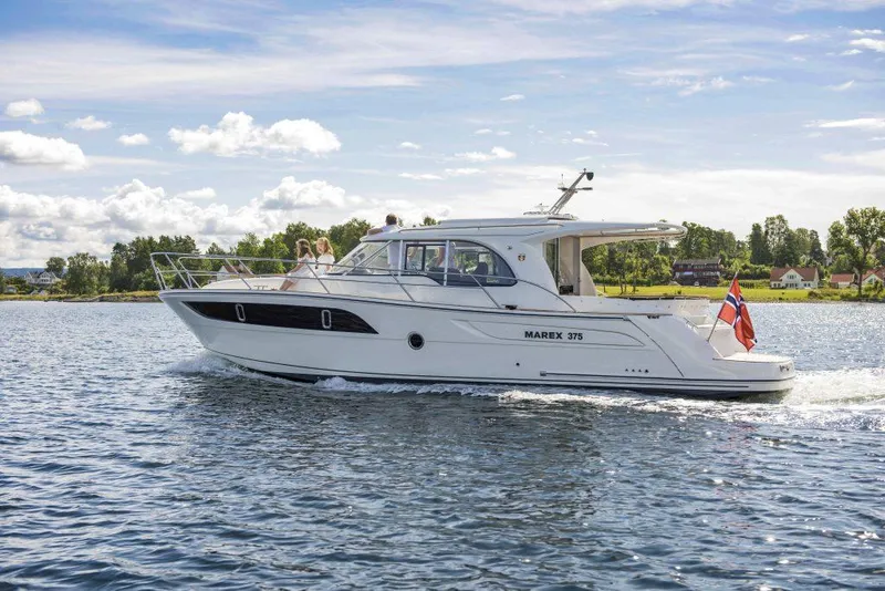 Slide: The Image of 2025 Marex 375 yacht cruising on a sunny day with scenic background. - 17