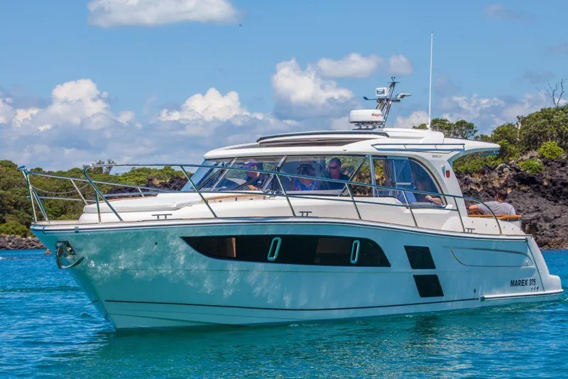 Slide: The Image of 2025 Marex 375 boat cruising on clear blue water under a sunny sky. - 18