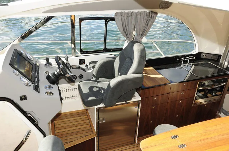 Slide: The Image of Modern Marex 375 yacht interior with helm, seating, and kitchenette, 2025 model. - 26