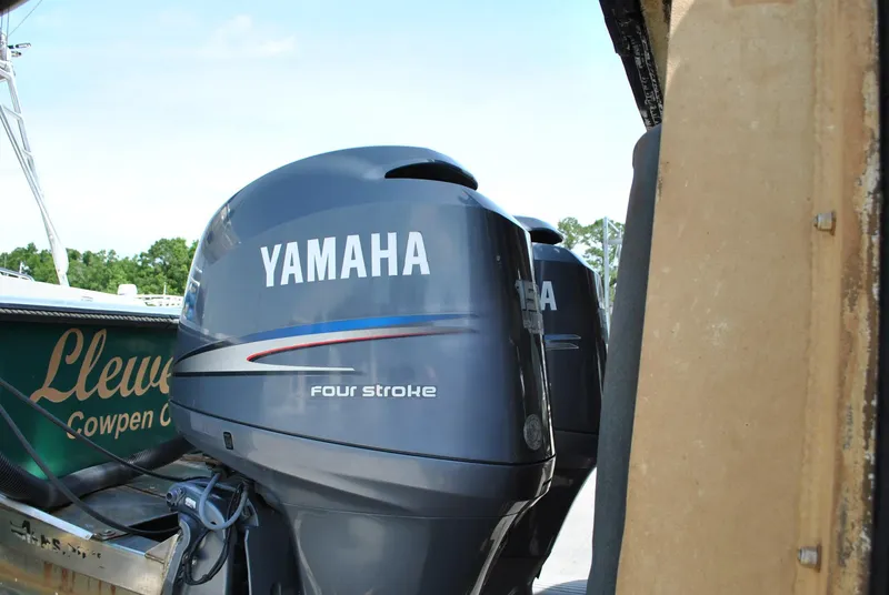 Slide: The Image of Yamaha four-stroke outboard engines on a 1987 Halter 31 Lafitte Skiff boat. - 11