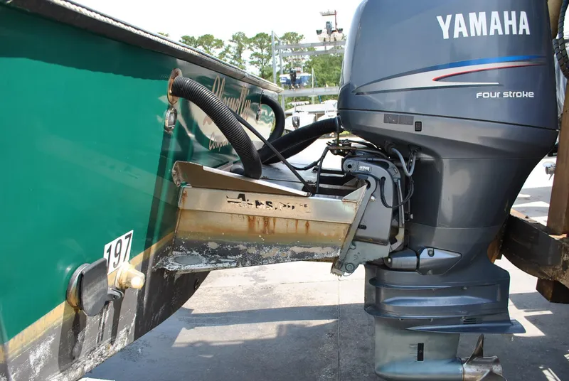 Slide: The Image of 1987 Halter 31 Lafitte Skiff with Yamaha four-stroke outboard motor, docked. - 13