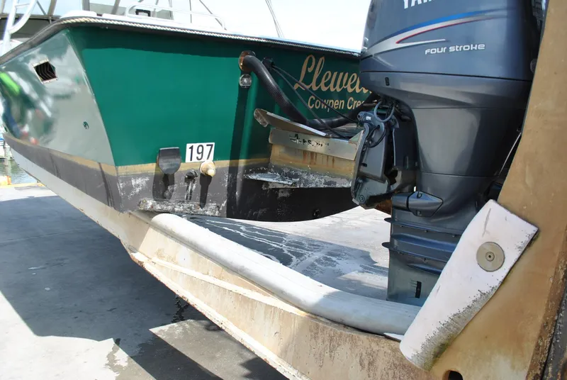 Slide: The Image of 1987 Halter 31 Lafitte Skiff with Yamaha outboard motor on trailer. - 14