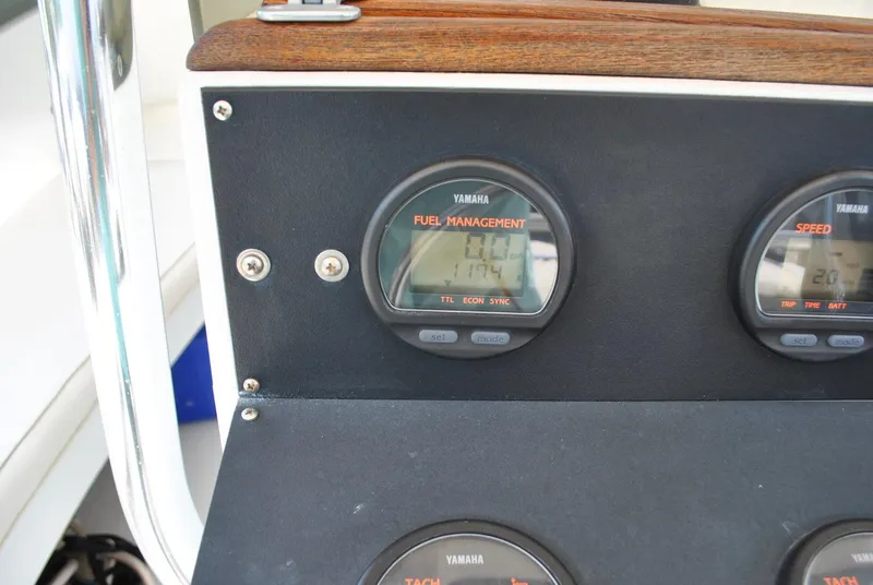 Slide: The Image of 1987 Halter 31 Lafitte Skiff dashboard with Yamaha fuel management gauges. - 22