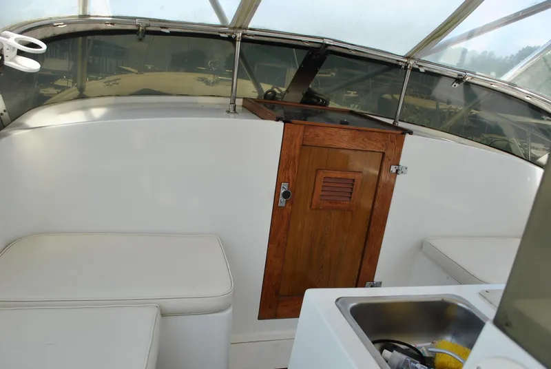 Slide: The Image of 1987 Halter 31 Lafitte Skiff interior with wooden cabinet and seating. - 25