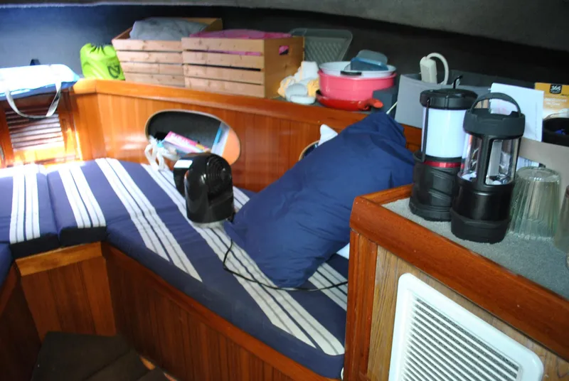 Slide: The Image of Interior of 1987 Halter 31 Lafitte Skiff with striped cushions and wooden accents. - 27