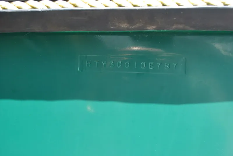 Slide: The Image of Halter 31 Lafitte Skiff 1987 hull identification number on green surface. - 3