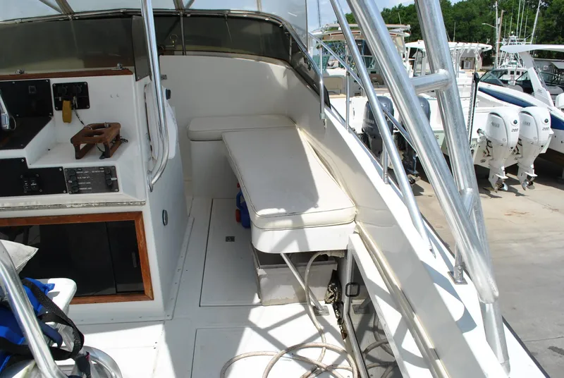 Slide: The Image of 1987 Halter 31 Lafitte Skiff boat interior with seating and control panel. - 34