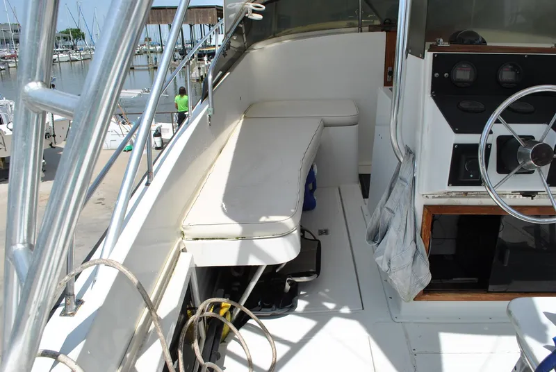 Slide: The Image of 1987 Halter 31 Lafitte Skiff boat interior with steering wheel and seating area. - 35