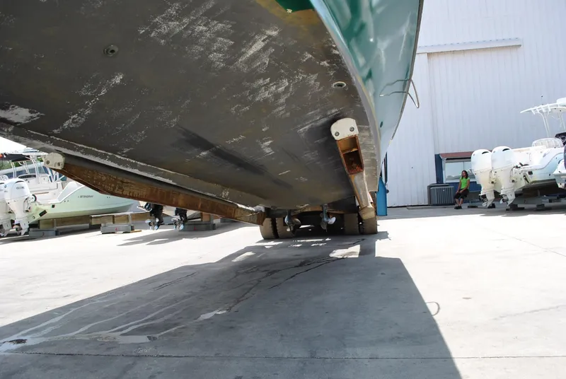 Slide: The Image of 1987 Halter 31 Lafitte Skiff boat hull on dry dock, underside view. - 37