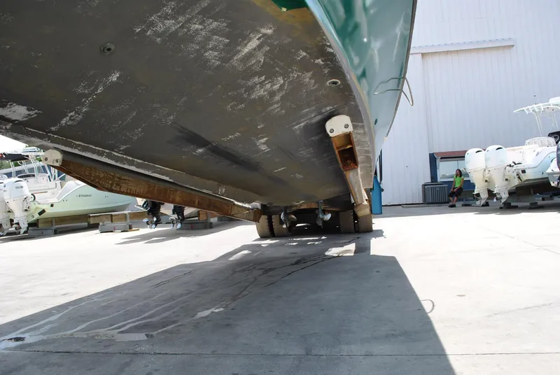 Slide: The Image of Underside view of a 1987 Halter 31 Lafitte Skiff boat on a trailer. - 38