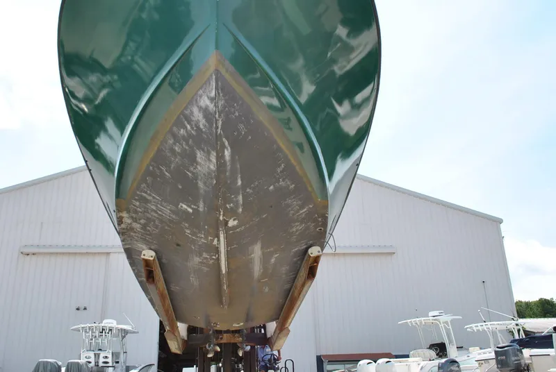 Slide: The Image of 1987 Halter 31 Lafitte Skiff boat hull, green and weathered, in a boatyard setting. - 39