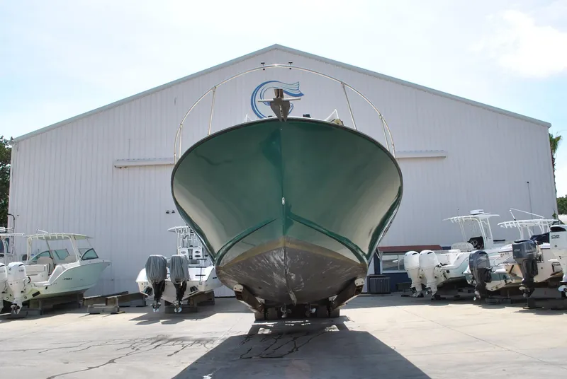 Slide: The Image of 1987 Halter 31 Lafitte Skiff boat on dry dock, surrounded by other vessels. - 5