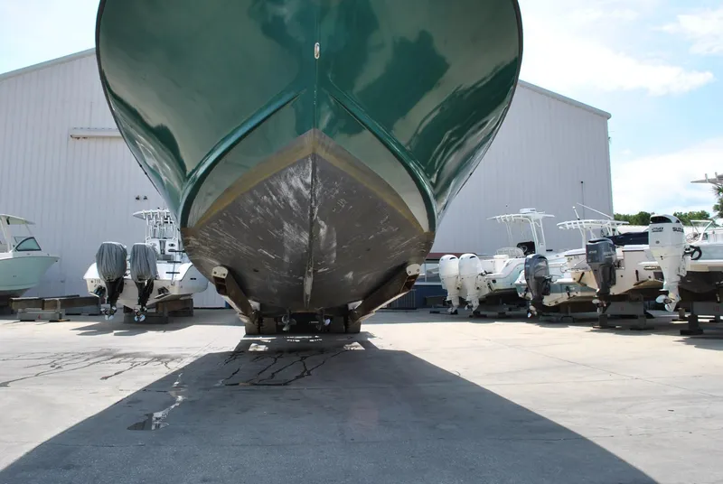 Slide: The Image of 1987 Halter 31 Lafitte Skiff boat on dry dock, surrounded by other vessels. - 6
