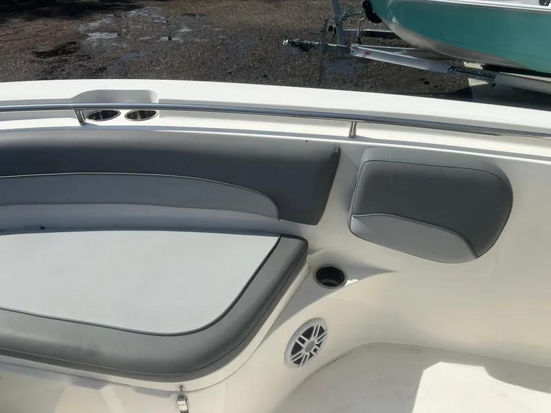 Slide: The Image of 2023 NauticStar 2602 Legacy boat interior with gray seating and cup holders. - 12