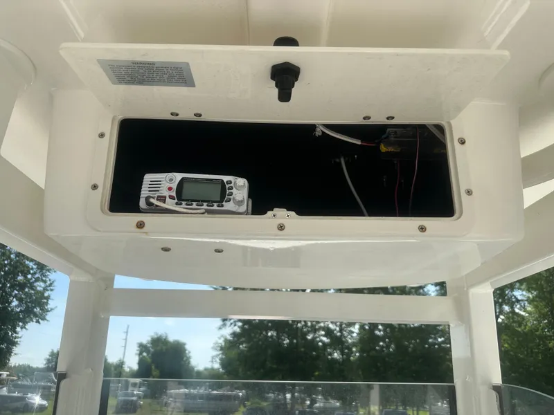 Slide: The Image of 2023 NauticStar 2602 Legacy boat console with electronic equipment storage. - 17