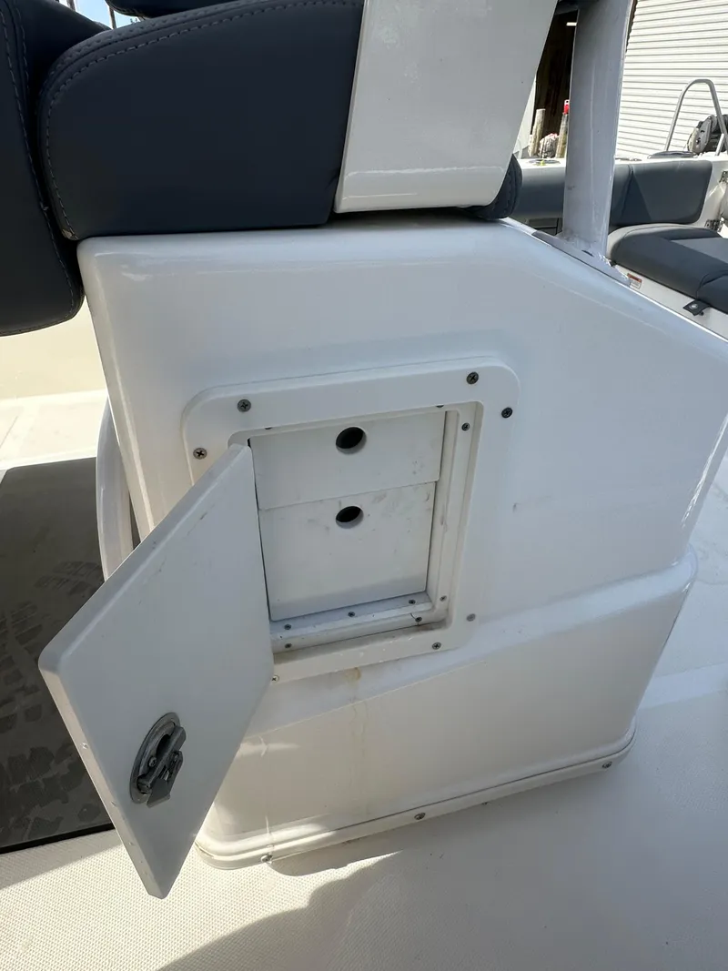 Slide: The Image of 2023 NauticStar 2602 Legacy boat storage compartment with open hatch. - 20