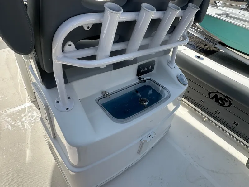 Slide: The Image of 2023 NauticStar 2602 Legacy boat with rod holders and livewell. - 23