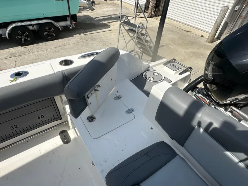 Slide: The Image of 2023 NauticStar 2602 Legacy boat interior with seating and storage compartments. - 25