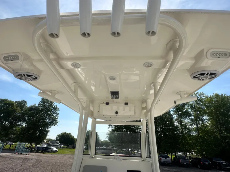 Slide: The Image of 2023 NauticStar 2602 Legacy boat canopy with rod holders and speakers. - 29