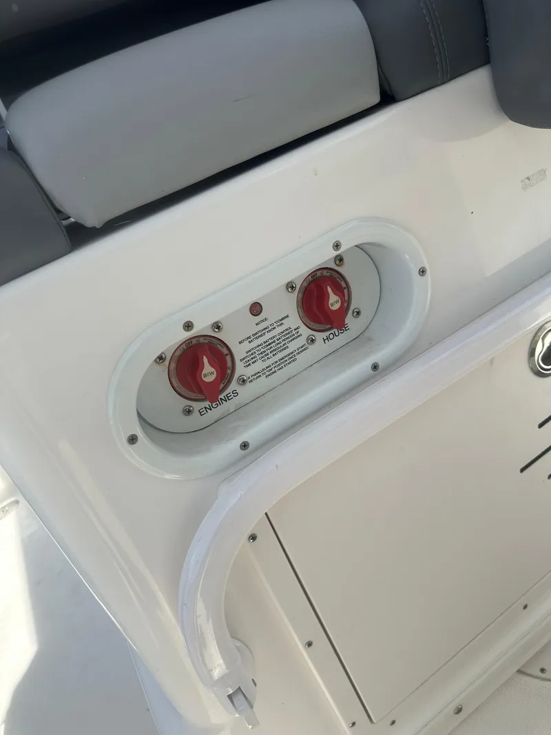 Slide: The Image of Control panel on 2023 NauticStar 2602 Legacy boat with red switches. - 35