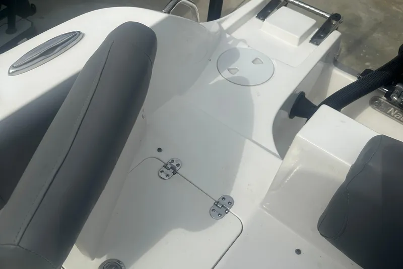 Slide: The Image of 2023 NauticStar 2602 Legacy boat interior with seating and storage compartments. - 37