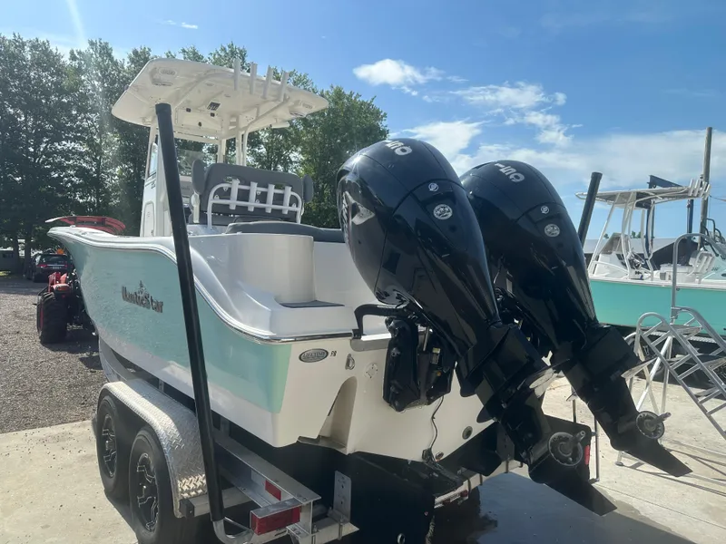 Slide: The Image of 2023 NauticStar 2602 Legacy boat with dual outboard motors on a trailer. - 4